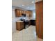 Traditional kitchen featuring brown wood cabinets and stainless steel appliances at 2828 Whispering Way, Winter Park, FL 32792