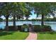 A view of a charming lakeside park with a serene boardwalk and a 'No Swimming' sign at 2828 Whispering Way, Winter Park, FL 32792
