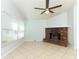 Bright living room featuring a brick fireplace, neutral walls, and tile flooring at 2828 Whispering Way, Winter Park, FL 32792