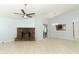 Open living space with brick fireplace, sliding door access to the patio, and a view into the kitchen at 2828 Whispering Way, Winter Park, FL 32792