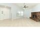 Spacious living room with a brick fireplace, ceiling fan, and neutral tile flooring at 2828 Whispering Way, Winter Park, FL 32792