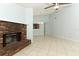Living room featuring a brick fireplace, neutral color palette, and open access to dining and kitchen areas at 2828 Whispering Way, Winter Park, FL 32792