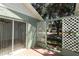 Outdoor patio area with sliding glass door access to the interior and greenery view at 2828 Whispering Way, Winter Park, FL 32792