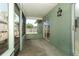 View of the enclosed patio with green walls and fenced-in views of the back yard at 2828 Whispering Way, Winter Park, FL 32792