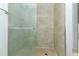 Walk-in shower featuring neutral tile, a glass door, and modern fixtures at 2828 Whispering Way, Winter Park, FL 32792