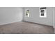 Bright bedroom features plush carpeting, two windows, and neutral paint, creating a cozy and inviting atmosphere at 2908 Lingo Ln, Orlando, FL 32822