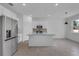 Open-concept kitchen boasts stainless steel appliances and a large island at 2908 Lingo Ln, Orlando, FL 32822