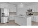 Modern kitchen featuring a large island, granite counters, and stainless steel appliances at 2908 Lingo Ln, Orlando, FL 32822