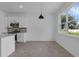 Bright and airy kitchen with white cabinets and a modern pendant light at 2908 Lingo Ln, Orlando, FL 32822