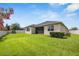 Expansive backyard featuring lush green grass, a screened-in patio, and well-maintained landscaping at 2938 Bushmead Ct, Ocoee, FL 34761