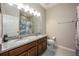 Bathroom features a double vanity, granite countertops, and tiled floors at 2938 Bushmead Ct, Ocoee, FL 34761