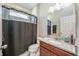 Cozy bathroom with walk-in shower, single vanity, and tiled floors at 2938 Bushmead Ct, Ocoee, FL 34761