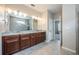 Bathroom features a double vanity, granite countertops, and access to a tiled walk-in shower at 2938 Bushmead Ct, Ocoee, FL 34761