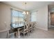 Bright dining room featuring modern chandelier and view of backyard at 2938 Bushmead Ct, Ocoee, FL 34761