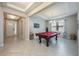 Spacious game room featuring tray ceilings, herringbone floors, and pool table at 2938 Bushmead Ct, Ocoee, FL 34761
