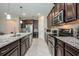 Close-up of gourmet kitchen featuring stainless appliances, granite countertops and herringbone floors at 2938 Bushmead Ct, Ocoee, FL 34761