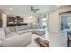 Bright and airy living room showing access to kitchen, dining room, and outdoor patio at 2938 Bushmead Ct, Ocoee, FL 34761