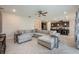 Open concept living room offering herringbone floors, with a view of the kitchen and dining room at 2938 Bushmead Ct, Ocoee, FL 34761