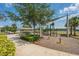 Community playground with a covered picnic area, climbing structures, and mature trees at 2938 Bushmead Ct, Ocoee, FL 34761