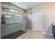 Walk-in shower featuring tile surround, rainfall shower head, and hand-held sprayer at 2938 Bushmead Ct, Ocoee, FL 34761