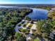 Aerial view of empty RV parking, a boat ramp, and the river in a wooded area at 305 Platform Ln, Debary, FL 32713