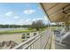Wide shot of golf course with golf carts, lake, sitting area, and patio furniture at 305 Platform Ln, Debary, FL 32713