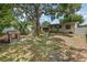 Expansive backyard with mature trees and an outdoor firepit seating area at 3416 Grant Blvd, Orlando, FL 32804