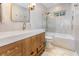 Modern bathroom features a shower and tub with glass screen plus a vanity with storage baskets at 3416 Grant Blvd, Orlando, FL 32804