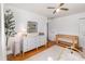 Spacious Bedroom featuring a crib, changing table, and plush rug on wood floors at 3416 Grant Blvd, Orlando, FL 32804