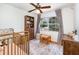 Comfortable Bedroom features a crib, chair, and table set with plush area rug at 3416 Grant Blvd, Orlando, FL 32804