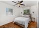 Well-lit bedroom with hardwood floors features a ceiling fan and large windows at 3416 Grant Blvd, Orlando, FL 32804