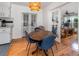 Cozy dining room with round table, blue chairs, and view to an office through french doors at 3416 Grant Blvd, Orlando, FL 32804