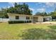 Charming single-story home featuring a well-manicured lawn, light yellow paint, and an inviting front porch at 3416 Grant Blvd, Orlando, FL 32804