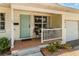 Inviting front porch with seating area, light paint and decorative front door at 3416 Grant Blvd, Orlando, FL 32804