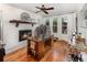 Bright home office featuring a fireplace, wood floors, a ceiling fan, and lots of natural light at 3416 Grant Blvd, Orlando, FL 32804