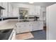 Bright kitchen with white cabinets, stainless steel sink and blue tile floors at 3416 Grant Blvd, Orlando, FL 32804