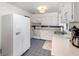 Bright kitchen with white cabinets, stainless steel sink and blue tile floors at 3416 Grant Blvd, Orlando, FL 32804