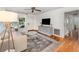 Bright living room featuring hardwood floors, a ceiling fan and neutral decor at 3416 Grant Blvd, Orlando, FL 32804