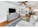Bright living room featuring hardwood floors, a ceiling fan and neutral decor that opens to dining and kitchen area at 3416 Grant Blvd, Orlando, FL 32804