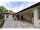 Outdoor living space featuring tiled flooring, covered patio and lush green lawn at 3437 Coronet Ave, Orlando, FL 32833