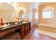 Spacious bathroom with double vanity, soaking tub and tiled walk-in shower, providing a luxurious retreat at 3437 Coronet Ave, Orlando, FL 32833