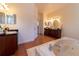 A luxury bathroom showcasing a large jacuzzi tub and dual dark wood vanities at 3437 Coronet Ave, Orlando, FL 32833