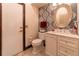 Well-lit half bathroom featuring vanity with a patterned wall, creating a chic and inviting space at 3437 Coronet Ave, Orlando, FL 32833