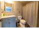 A bright bathroom featuring a combination shower and tub with tiled walls and modern fixtures at 3437 Coronet Ave, Orlando, FL 32833