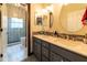 Bathroom featuring dual sinks, mirrors, vanity and tiled shower for a practical and stylish space at 3437 Coronet Ave, Orlando, FL 32833