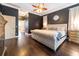 Primary bedroom featuring hard wood flooring, a king bed, fireplace, and ensuite bathroom at 3437 Coronet Ave, Orlando, FL 32833