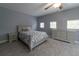 A cozy bedroom showcasing a plush bed, a ceiling fan, and coordinated furniture at 3437 Coronet Ave, Orlando, FL 32833