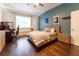 Spacious bedroom features a bed, desk, and modern decor, creating a comfortable and stylish living space at 3437 Coronet Ave, Orlando, FL 32833