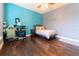 Bedroom featuring a bed, desk, and colorful decor, creating a comfortable and inviting living space at 3437 Coronet Ave, Orlando, FL 32833