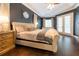 Primary bedroom featuring hard wood flooring, a king bed, and ensuite bathroom at 3437 Coronet Ave, Orlando, FL 32833